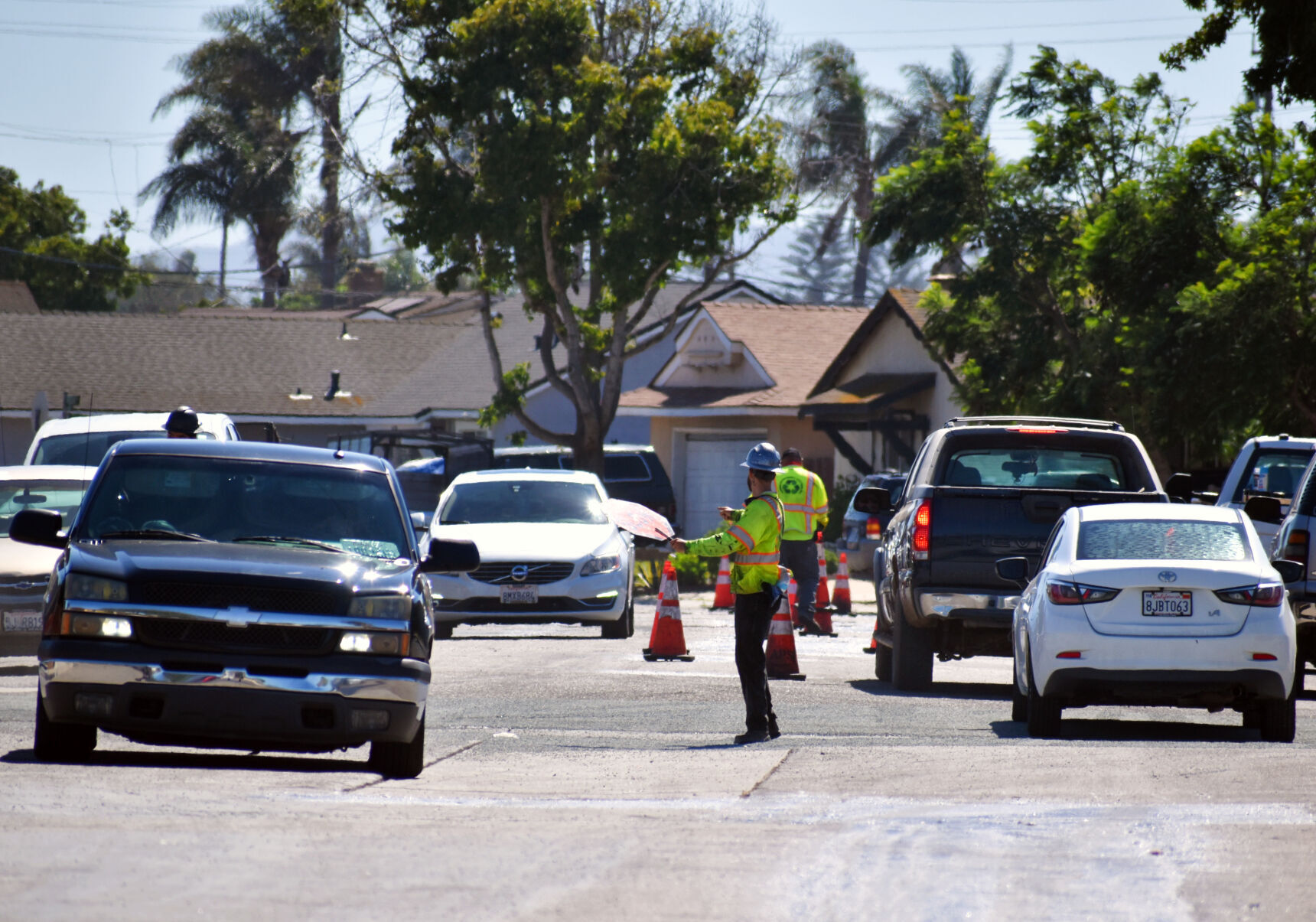 A construction worker works traffic on Western Ave. through residential Thursday afternoon.